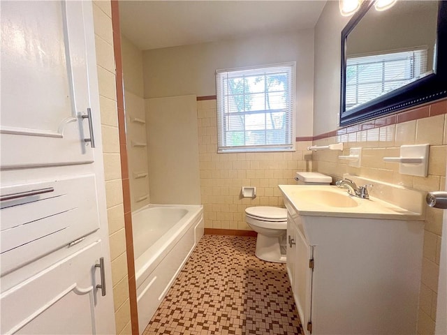 bathroom featuring a tub to relax in, tile walls, vanity, and toilet