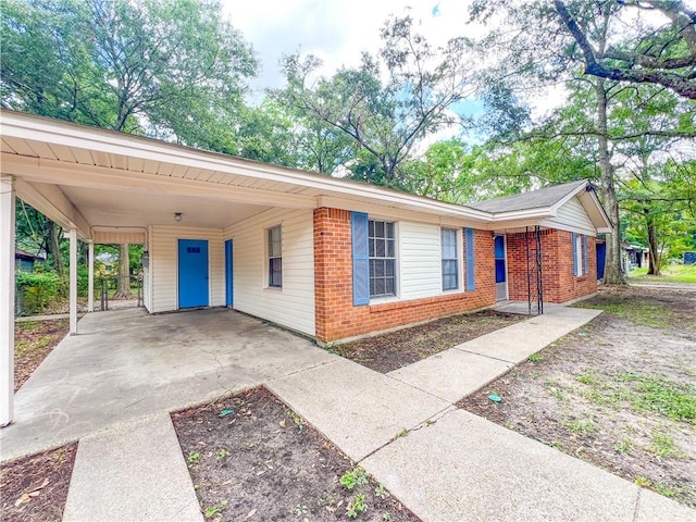 single story home featuring a carport