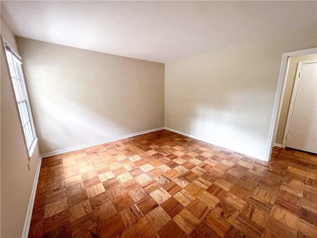 empty room featuring light parquet flooring and a healthy amount of sunlight