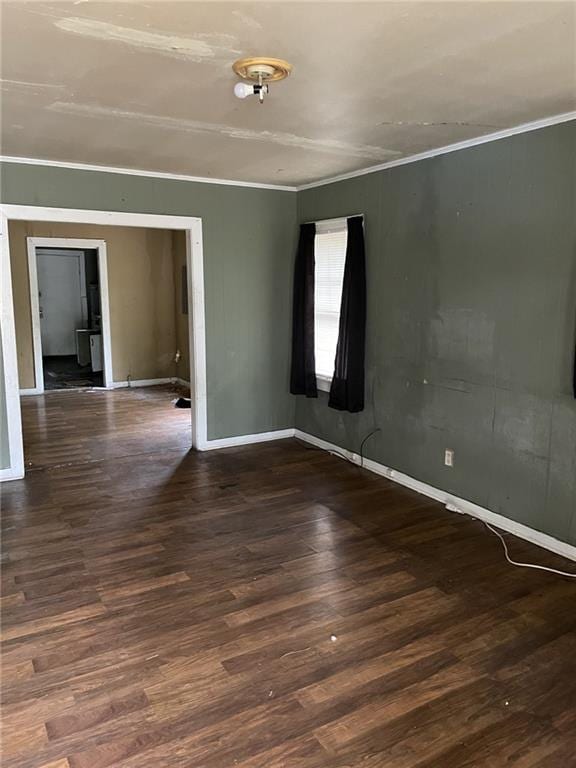 unfurnished room with dark wood-type flooring and ornamental molding