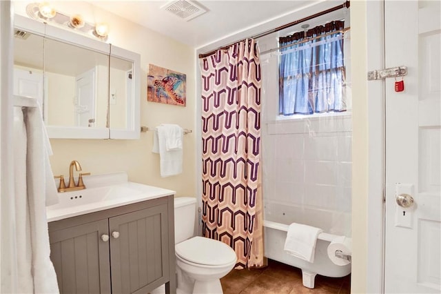 full bathroom featuring vanity, shower / bath combo with shower curtain, toilet, and tile patterned floors