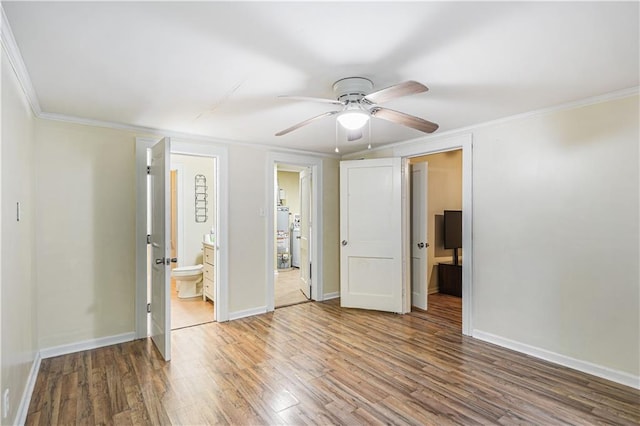 unfurnished bedroom with ceiling fan, hardwood / wood-style floors, ornamental molding, and ensuite bath