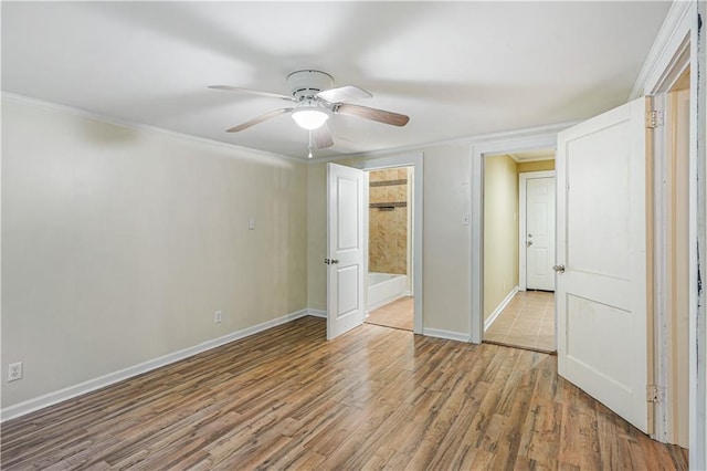 unfurnished bedroom with ceiling fan and hardwood / wood-style floors