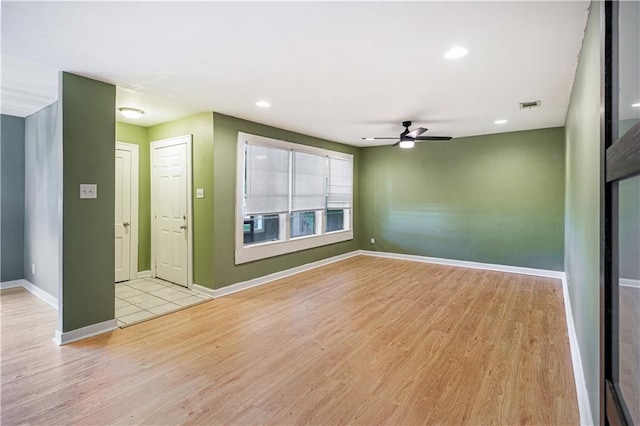 unfurnished room featuring ceiling fan and light hardwood / wood-style flooring