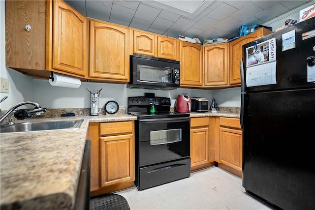 kitchen featuring sink and black appliances