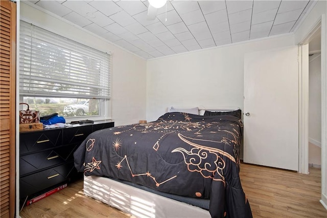 bedroom with crown molding and wood-type flooring