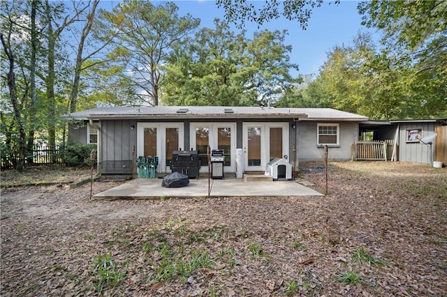 rear view of house with a patio area and french doors