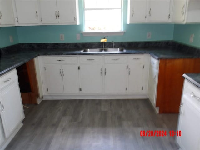 kitchen featuring dark hardwood / wood-style floors, white cabinetry, and sink