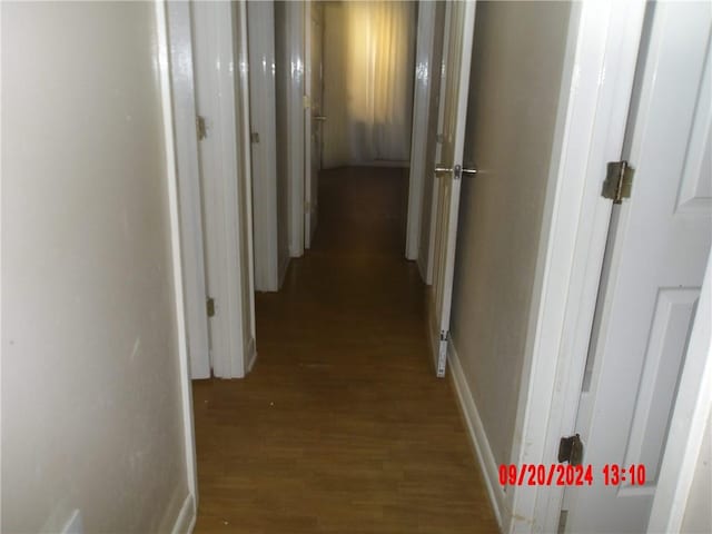 hallway with hardwood / wood-style floors