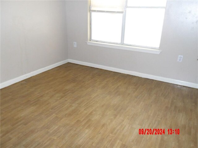 unfurnished room with hardwood / wood-style flooring