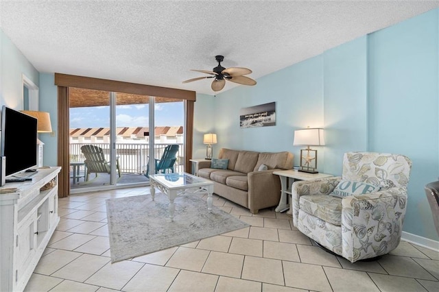 633 Beach Blvd Unit 205, Gulf Shores, AL 36542 - living area featuring ceiling fan, a textured ceiling, and light tile patterned floors