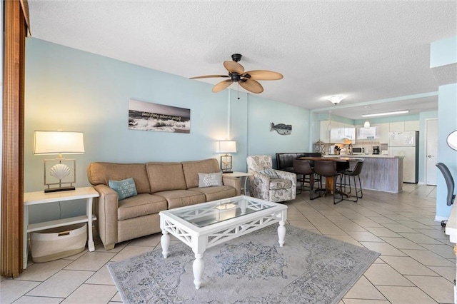 633 Beach Blvd Unit 205, Gulf Shores, AL 36542 - living area with light tile patterned floors, ceiling fan, and a textured ceiling