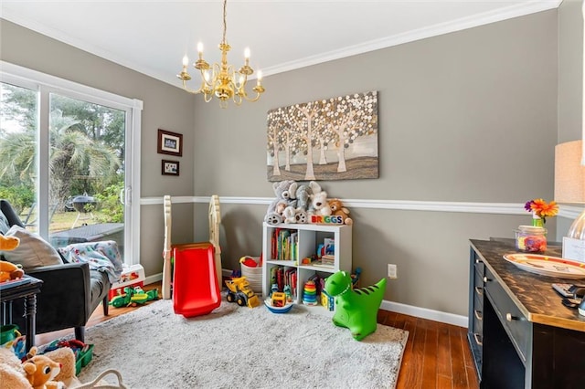 game room featuring a chandelier, dark wood-type flooring, and ornamental molding