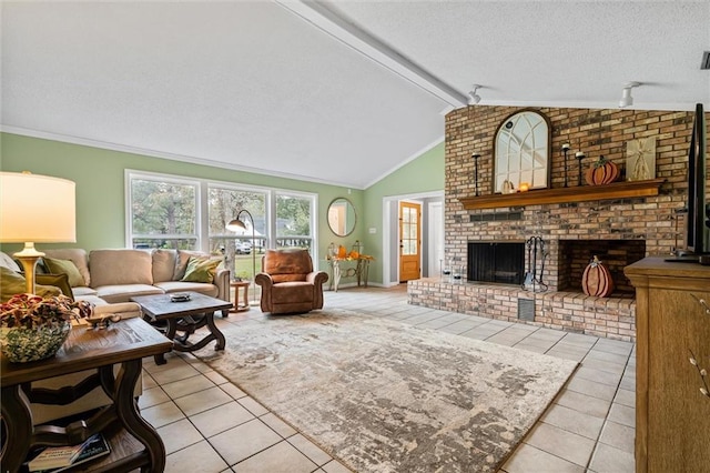 tiled living room with rail lighting, a brick fireplace, a textured ceiling, ceiling fan, and lofted ceiling