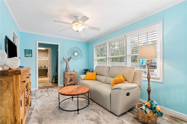 living room featuring ceiling fan, light hardwood / wood-style floors, and ornamental molding