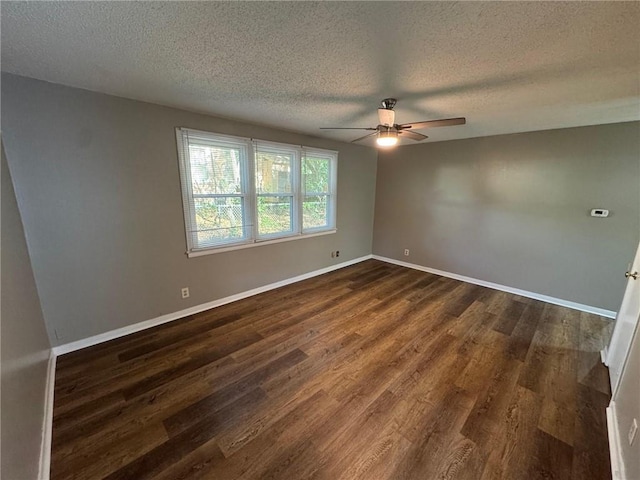 spare room with dark hardwood / wood-style flooring, a textured ceiling, and ceiling fan