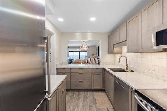 1051 Beach Blvd W Unit 9B, Gulf Shores, AL 36542 - kitchen featuring stainless steel appliances, light wood-type flooring, decorative backsplash, and recessed lighting