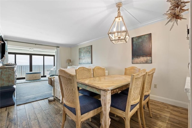 1051 Beach Blvd W Unit 9B, Gulf Shores, AL 36542 - dining room featuring ornamental molding, a chandelier, and wood finished floors