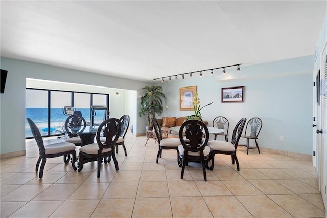 1051 Beach Blvd W Unit 9B, Gulf Shores, AL 36542 - dining room featuring rail lighting and light tile patterned flooring