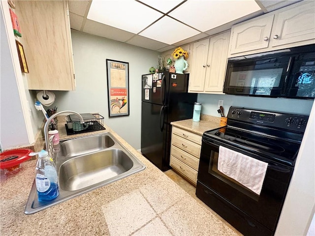 2081 Sea Cliff Dr N Unit 2B, Daphne, AL 36526 - kitchen featuring black appliances, a sink, light countertops, and a paneled ceiling