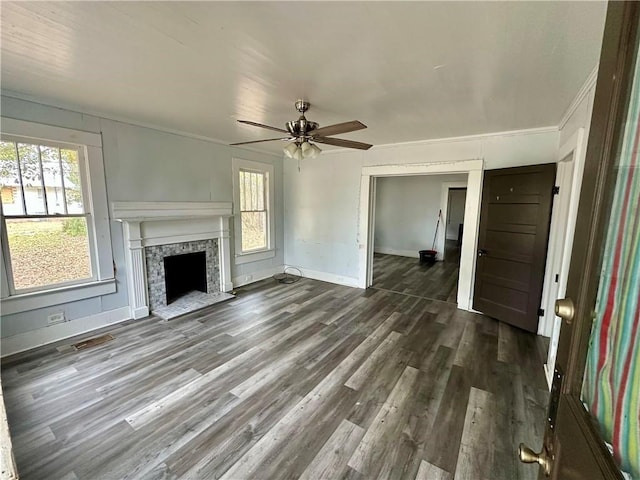 unfurnished living room featuring ceiling fan, dark hardwood / wood-style flooring, and ornamental molding