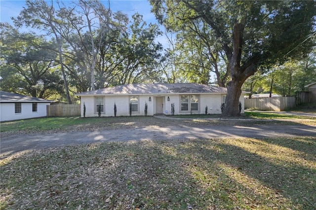 ranch-style house with a front lawn