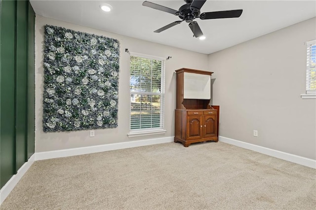 spare room with light carpet and ceiling fan