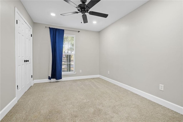 unfurnished room with carpet flooring and ceiling fan