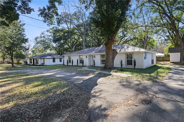 ranch-style home with a front lawn