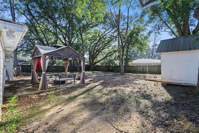 view of yard with a gazebo, a shed, and central air condition unit