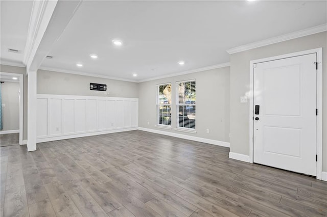 unfurnished living room with ornamental molding and light hardwood / wood-style flooring