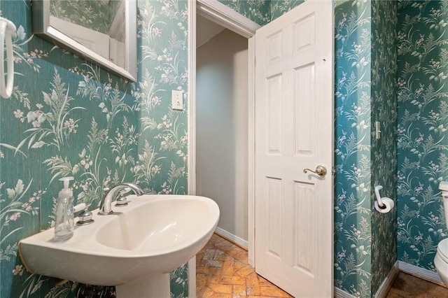 6412 Angela Ct, Mobile, AL 36695 - half bathroom with stone tile floors and wallpapered walls