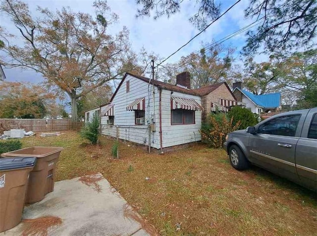 view of side of home with a lawn