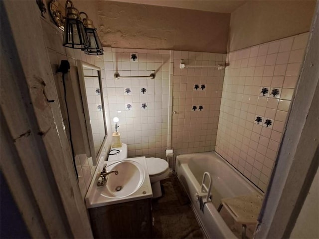 full bathroom featuring vanity, toilet, tiled shower / bath combo, and tile walls