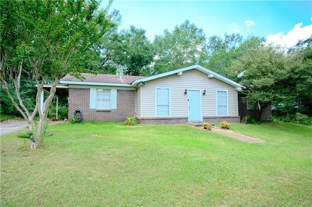 ranch-style home featuring brick siding and a front yard