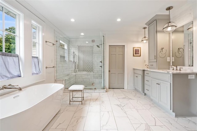 bathroom with vanity and shower with separate bathtub