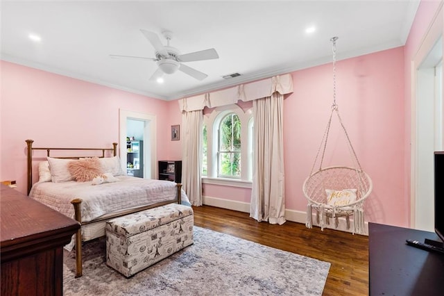 bedroom with crown molding, ceiling fan, and dark hardwood / wood-style flooring