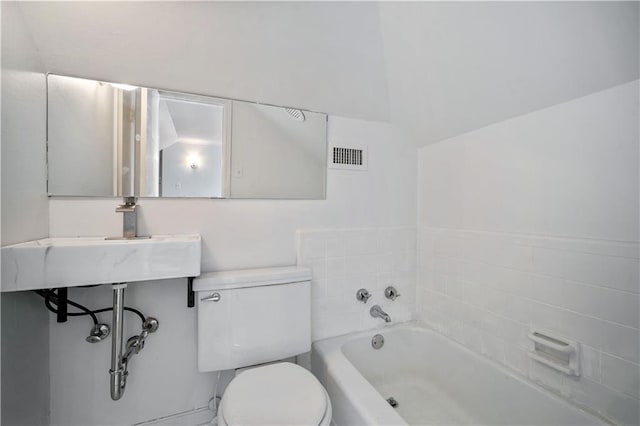 bathroom featuring visible vents, a sink, a bathing tub, and toilet