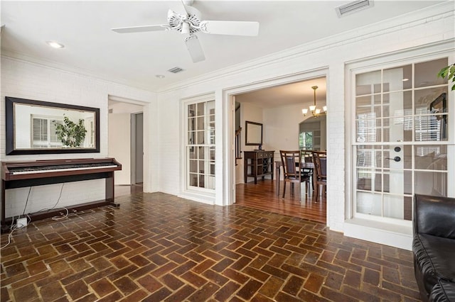 interior space featuring brick floor, visible vents, and ornamental molding