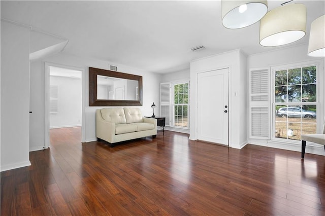 interior space with wood finished floors, visible vents, and baseboards