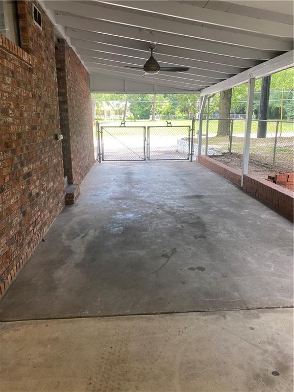 garage featuring visible vents, fence, and a gate