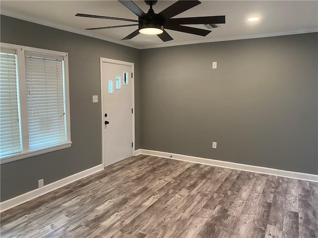 entrance foyer featuring a ceiling fan, baseboards, dark wood-type flooring, and crown molding