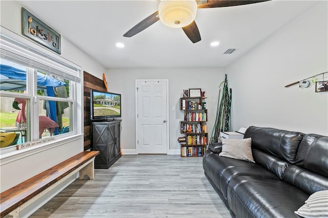 living room with ceiling fan and light hardwood / wood-style floors