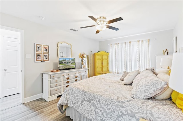 bedroom with light wood-type flooring and ceiling fan