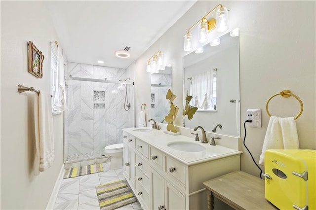 bathroom with a shower with door, toilet, vanity, and tile patterned floors