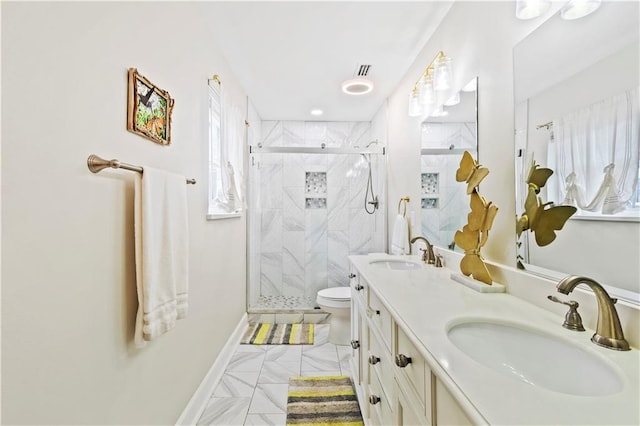 bathroom with a shower with door, vanity, and toilet