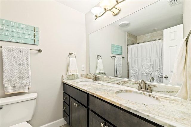 bathroom featuring walk in shower, vanity, and toilet