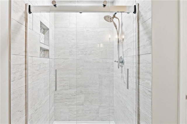 bathroom featuring a shower with shower door