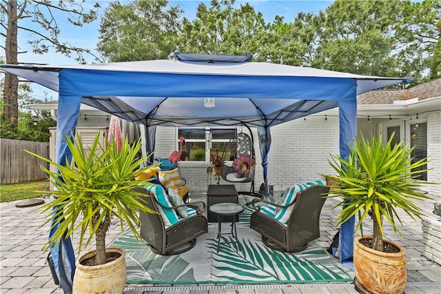 view of patio with an outdoor living space and a gazebo