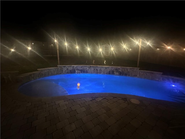 view of pool at night